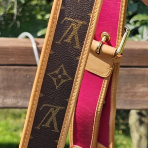 Adjustable Monogram canvas shoulder strap for the Louis Vuitton Perforated Musette held in hand