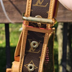 Buckle and adjustment holes on the Monogram strap of the Louis Vuitton Perforated Musette