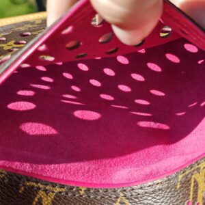 Bright fuchsia perforated leather panel inside the Louis Vuitton Monogram Perforated Musette