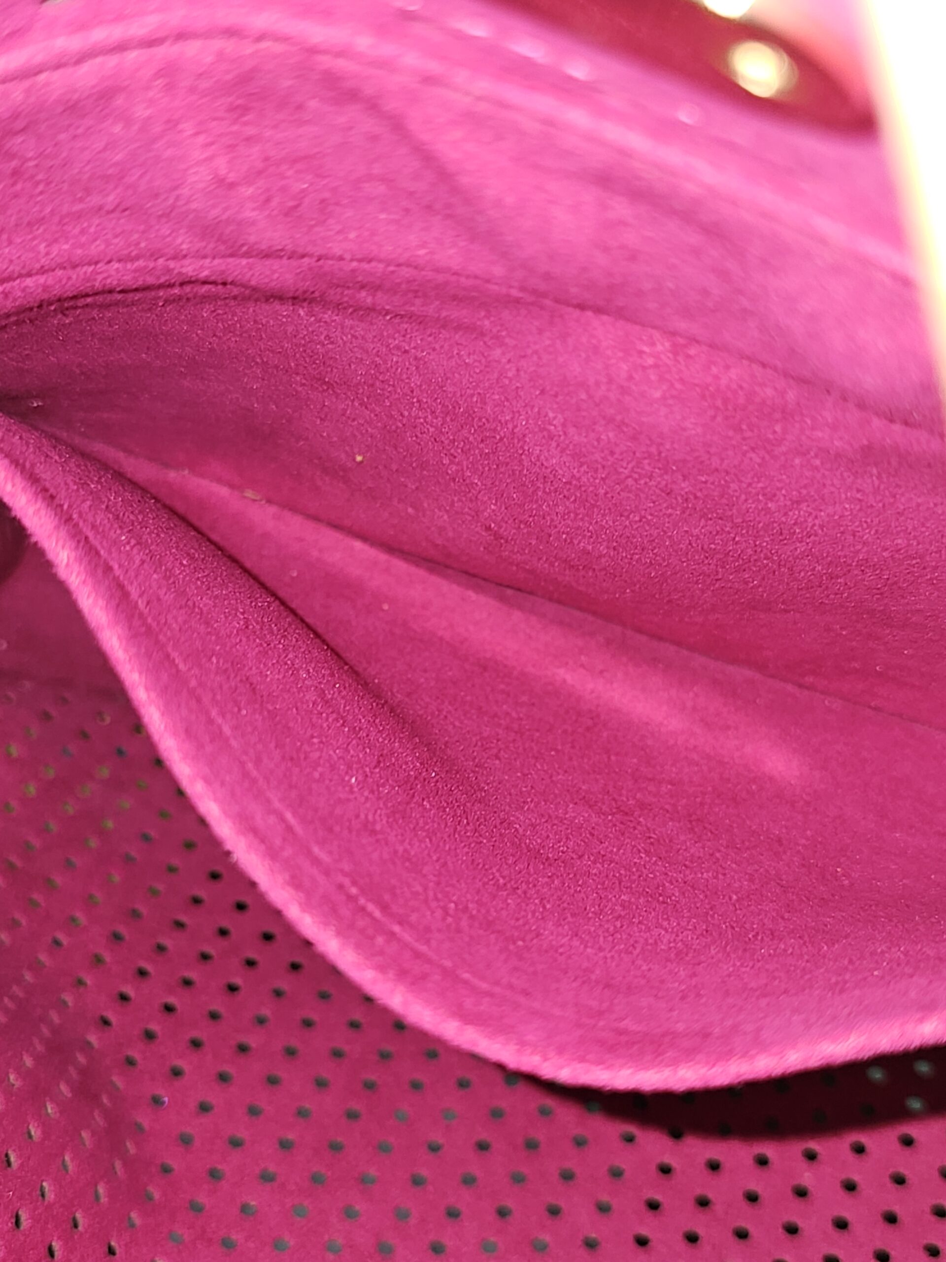 Fuchsia interior lining of the Louis Vuitton Monogram Perforated Musette