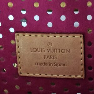 Louis Vuitton Paris made in Spain heat stamp on the fuchsia interior of the Perforated Musette