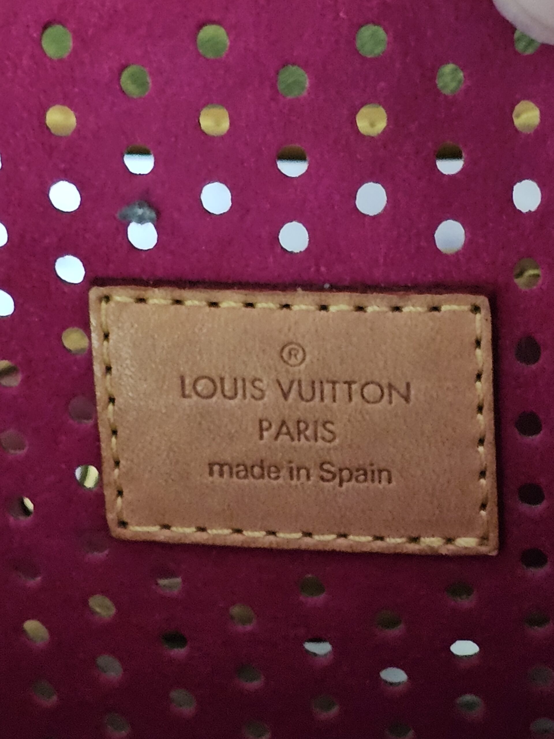 Louis Vuitton Paris made in Spain heat stamp on the fuchsia interior of the Perforated Musette