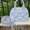 Louis Vuitton Alma BB in Ice Blue Bubblegram calfskin shown with its jacquard strap and Louis Vuitton dust bag