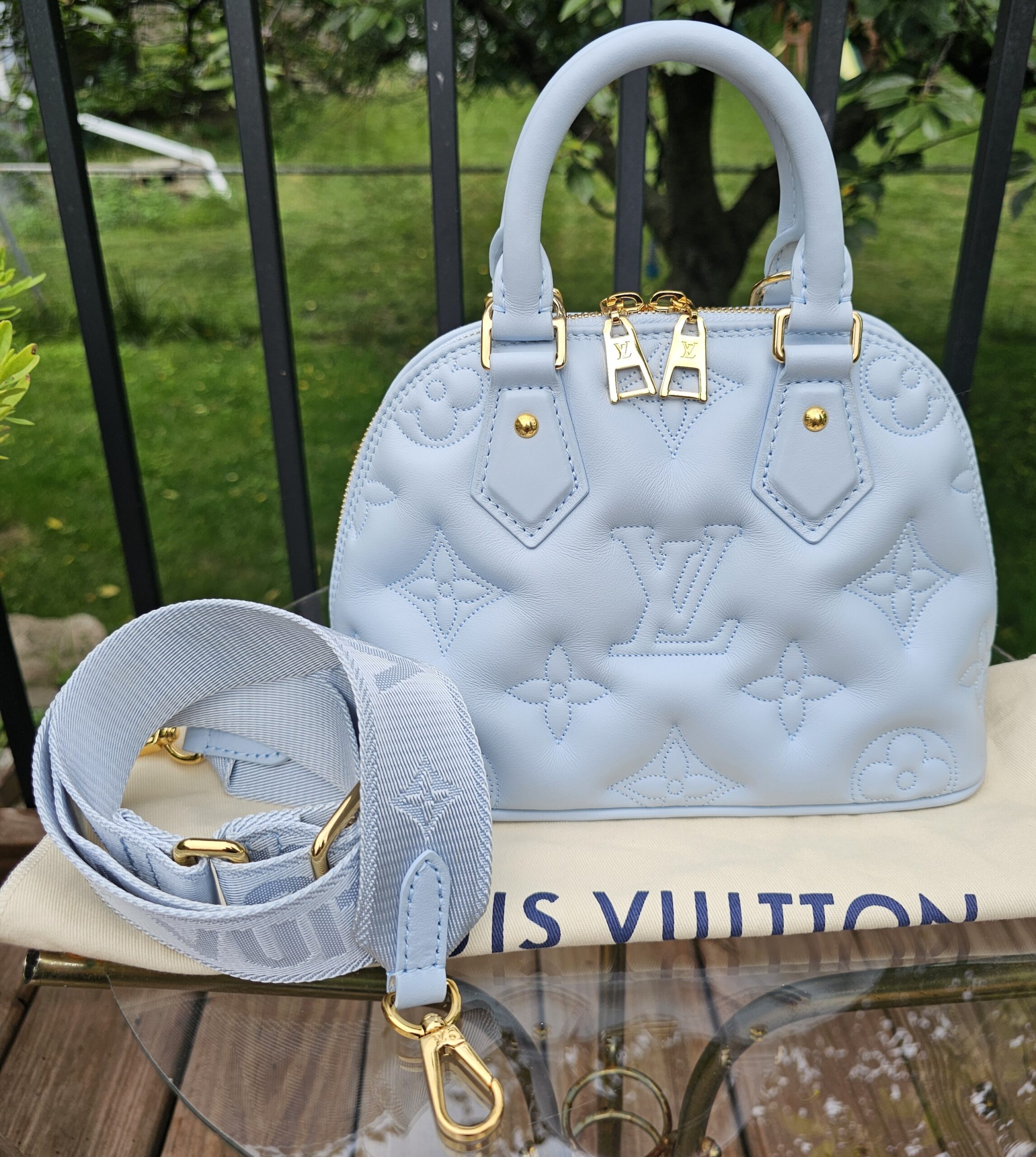 Louis Vuitton Alma BB in Ice Blue Bubblegram calfskin shown with its jacquard strap and Louis Vuitton dust bag
