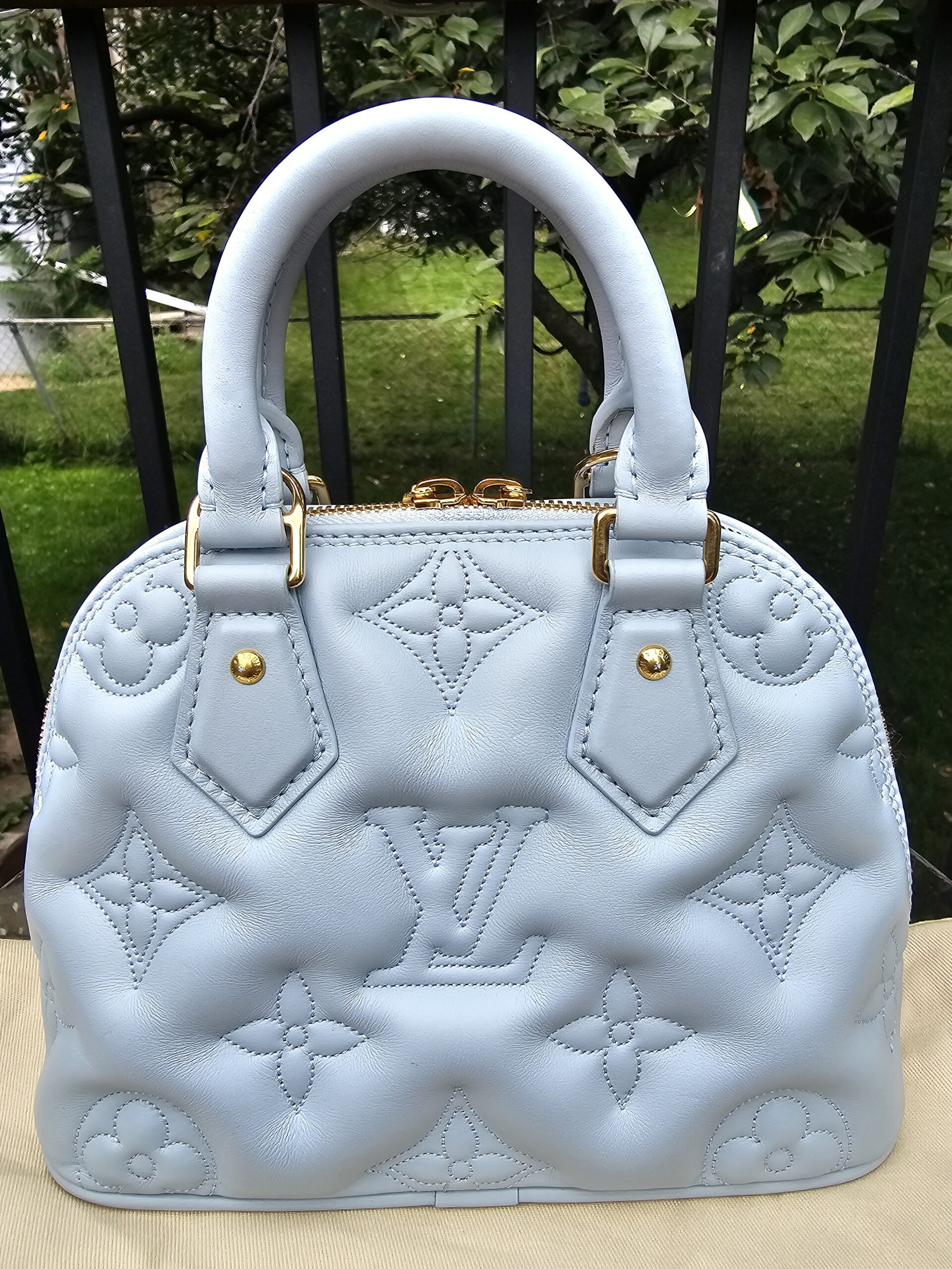 Back of the Louis Vuitton Bubblegram Alma BB showing the quilted Monogram pattern in Ice Blue calfskin