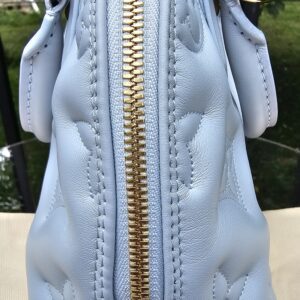 Gold-tone double zip closure along the top of the Louis Vuitton Bubblegram Alma BB