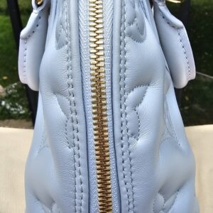 Side profile of the Louis Vuitton Bubblegram Alma BB in Ice Blue calfskin