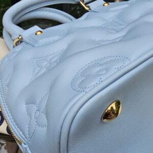 Oversized stitched Monogram detailing on the Ice Blue Bubblegram calfskin of the Alma BB