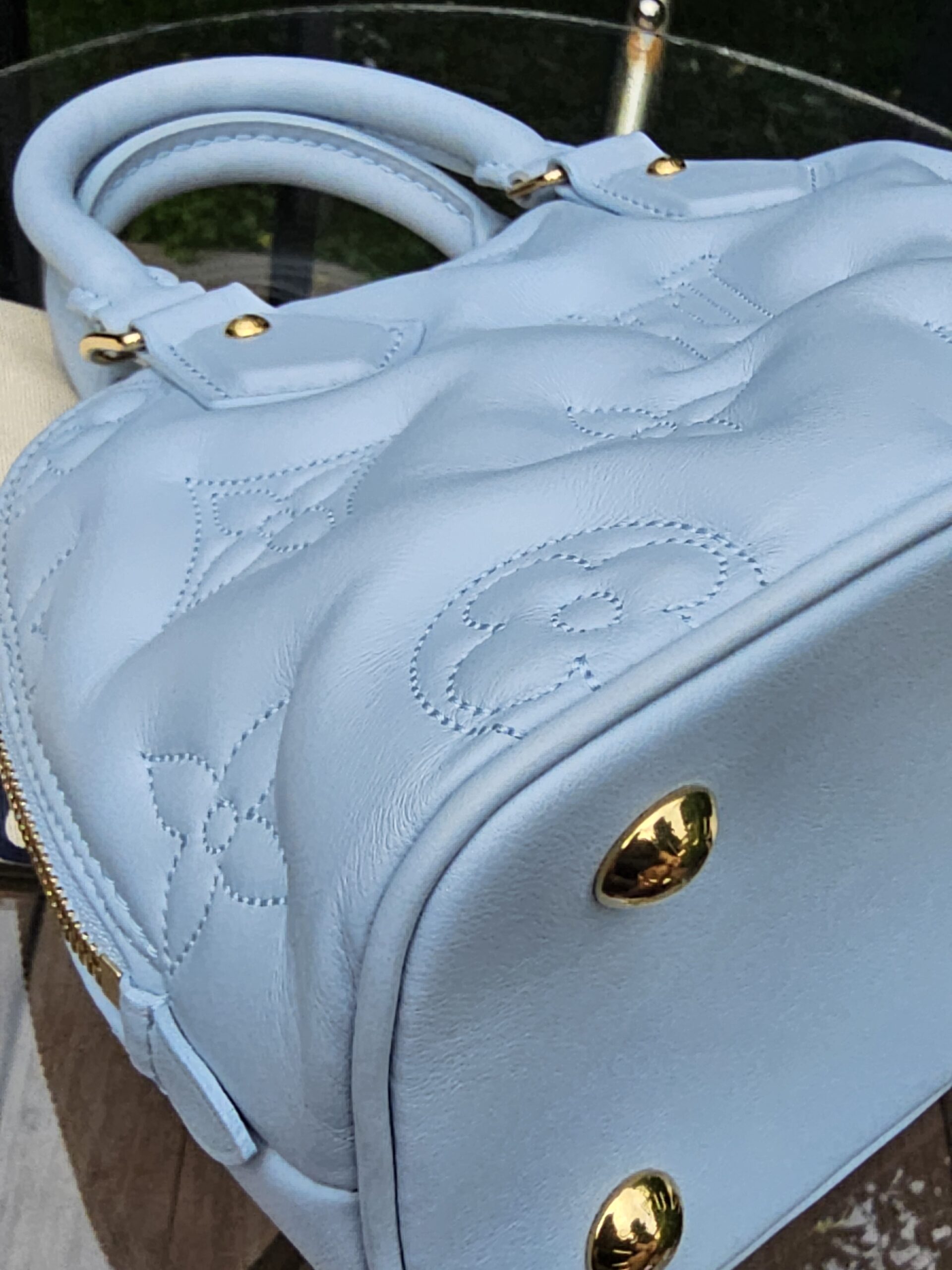 Side panel and gold stud of the Louis Vuitton Bubblegram Alma BB