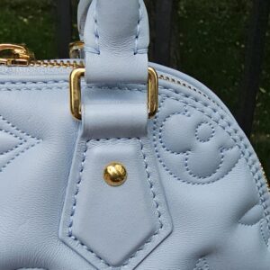Ice Blue Bubblegram calfskin of the Louis Vuitton Alma BB shown for light natural creasing