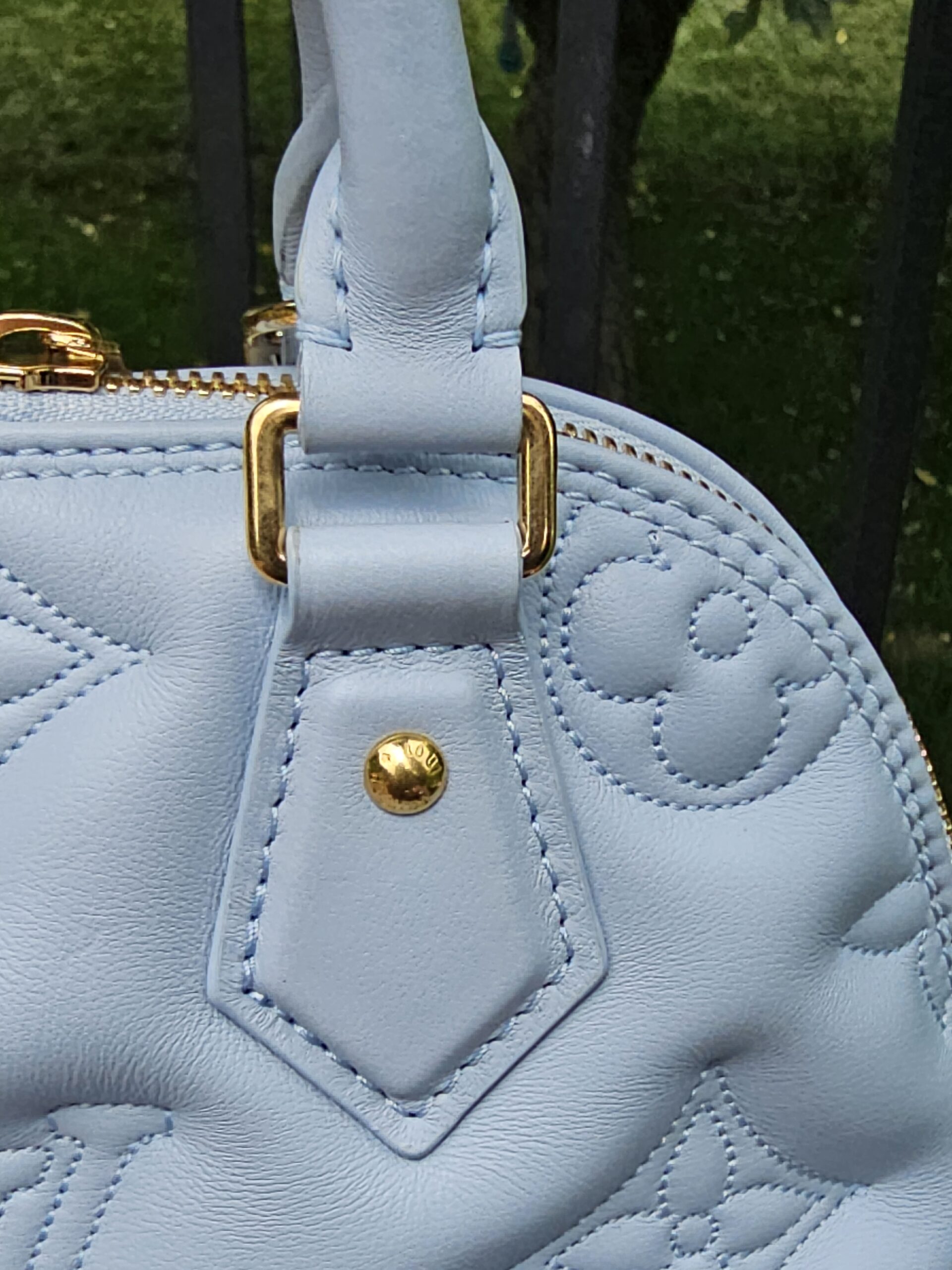 Ice Blue Bubblegram calfskin of the Louis Vuitton Alma BB shown for light natural creasing