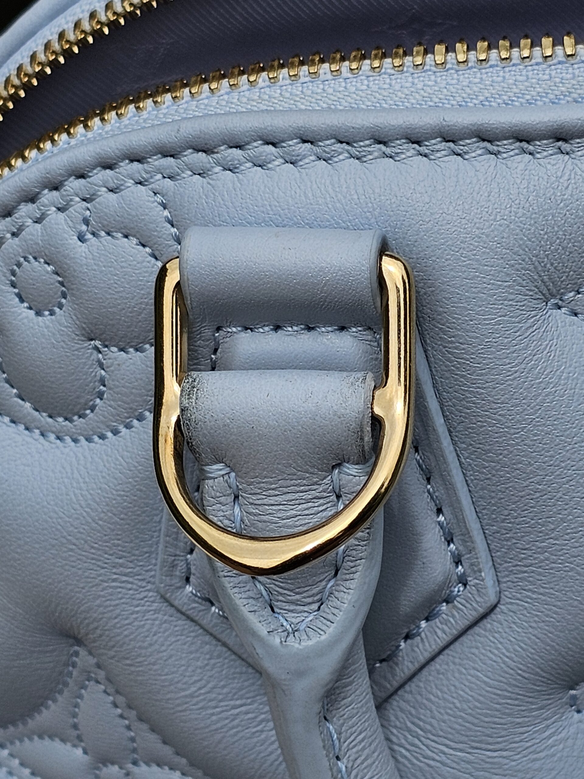Gold-tone D-ring for the removable strap on the Louis Vuitton Bubblegram Alma BB