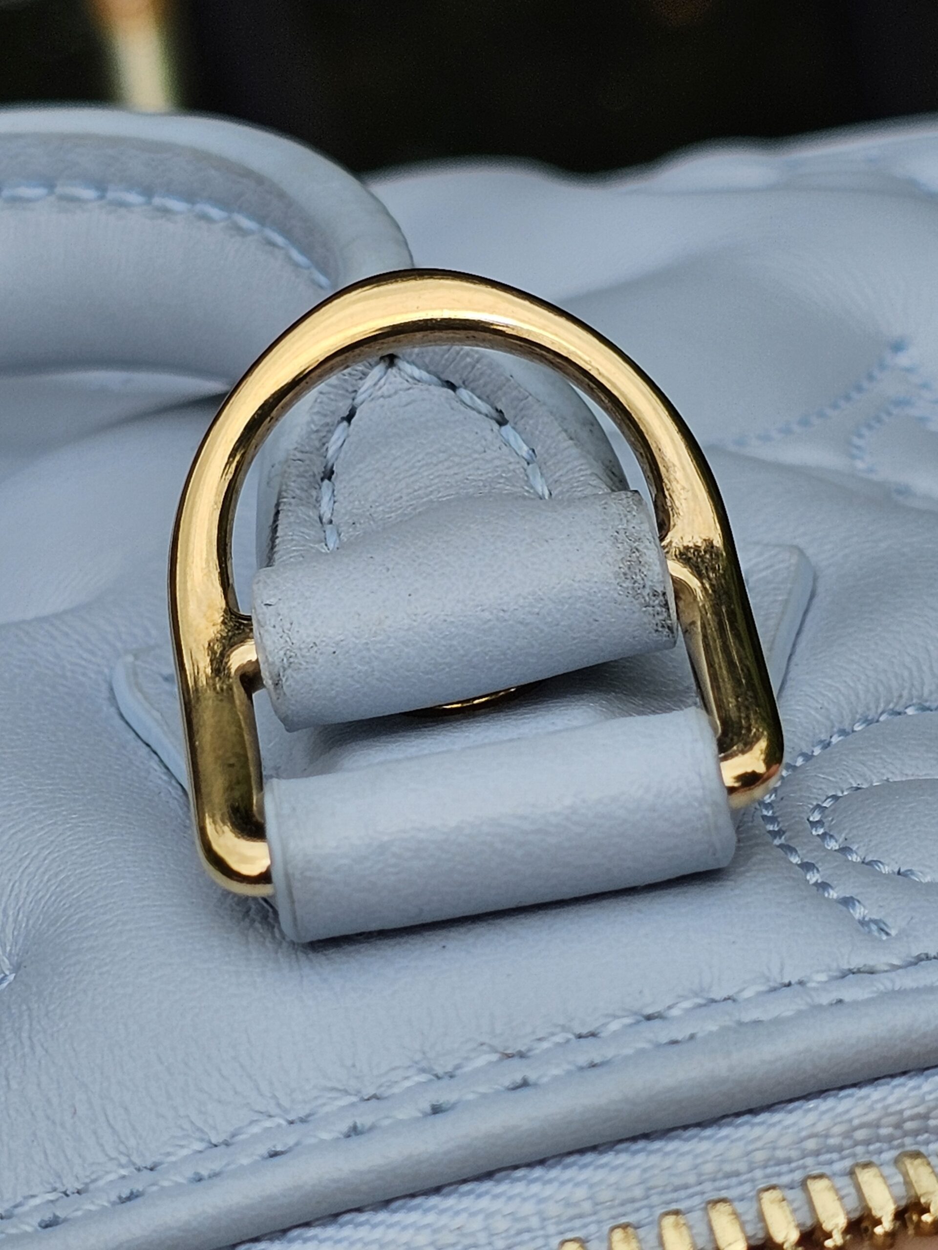 D-ring attachment area of the Louis Vuitton Bubblegram Alma BB showing light rubbing from use
