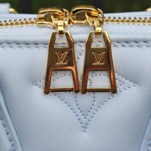Gold-tone LV engraved zip pulls on the Louis Vuitton Bubblegram Alma BB