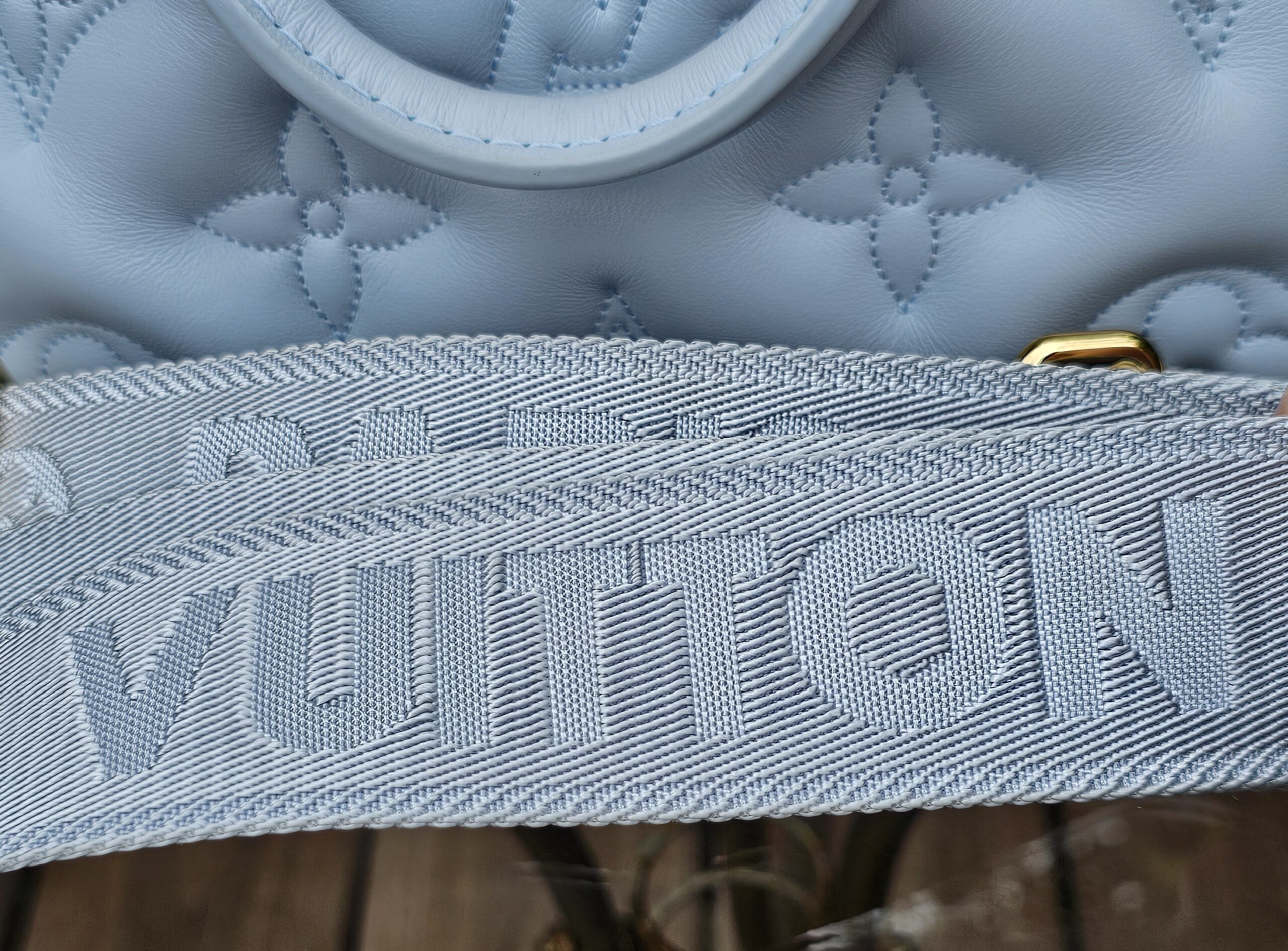 Louis Vuitton lettering woven into the jacquard strap of the Bubblegram Alma BB