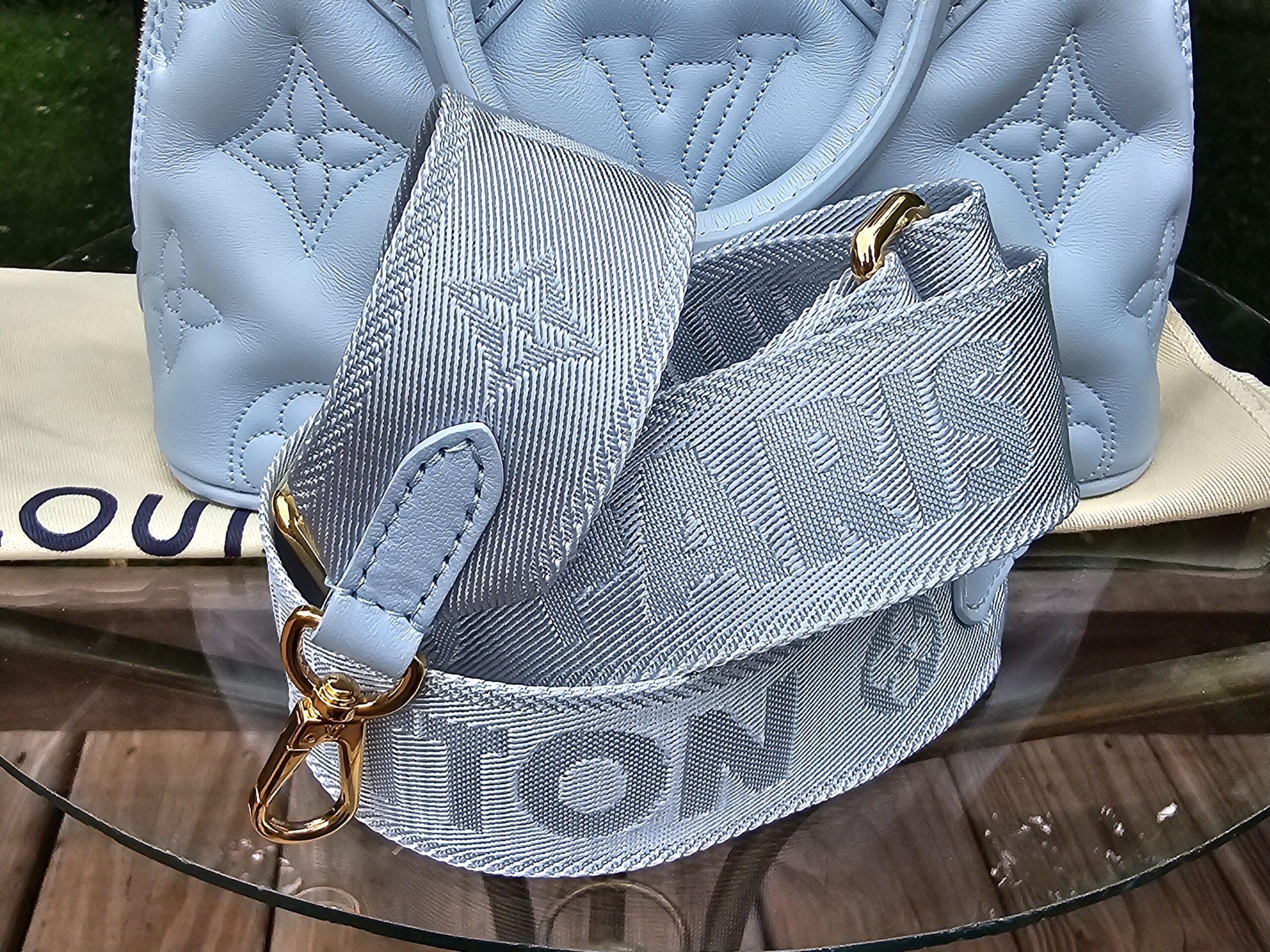 Louis Vuitton Bubblegram Alma BB in Ice Blue with the wide jacquard strap attached