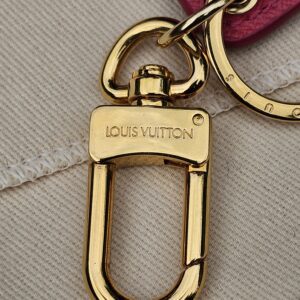 Gold-tone clasp stamped Louis Vuitton on the Illustre Pink Carousel key holder