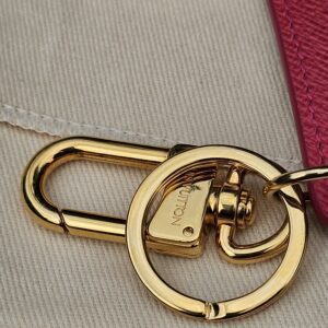 Close-up of the gold-tone clasp and ring hardware on the Louis Vuitton Illustre Carousel charm