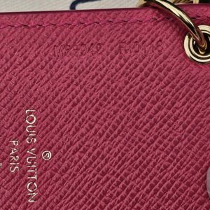 Pink grained leather backing of the Louis Vuitton Illustre Carousel charm