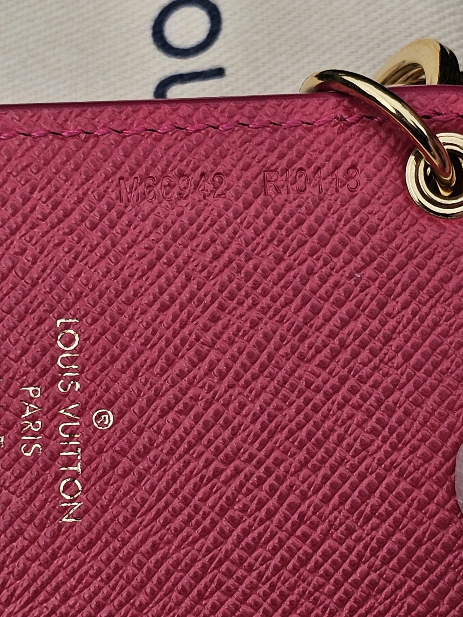 Pink grained leather backing of the Louis Vuitton Illustre Carousel charm