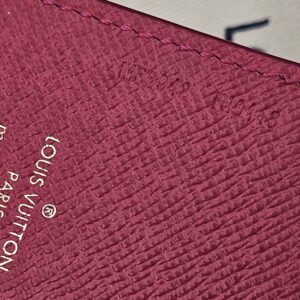 Close-up of the pink leather and Louis Vuitton Paris stamp on the Illustre Carousel charm