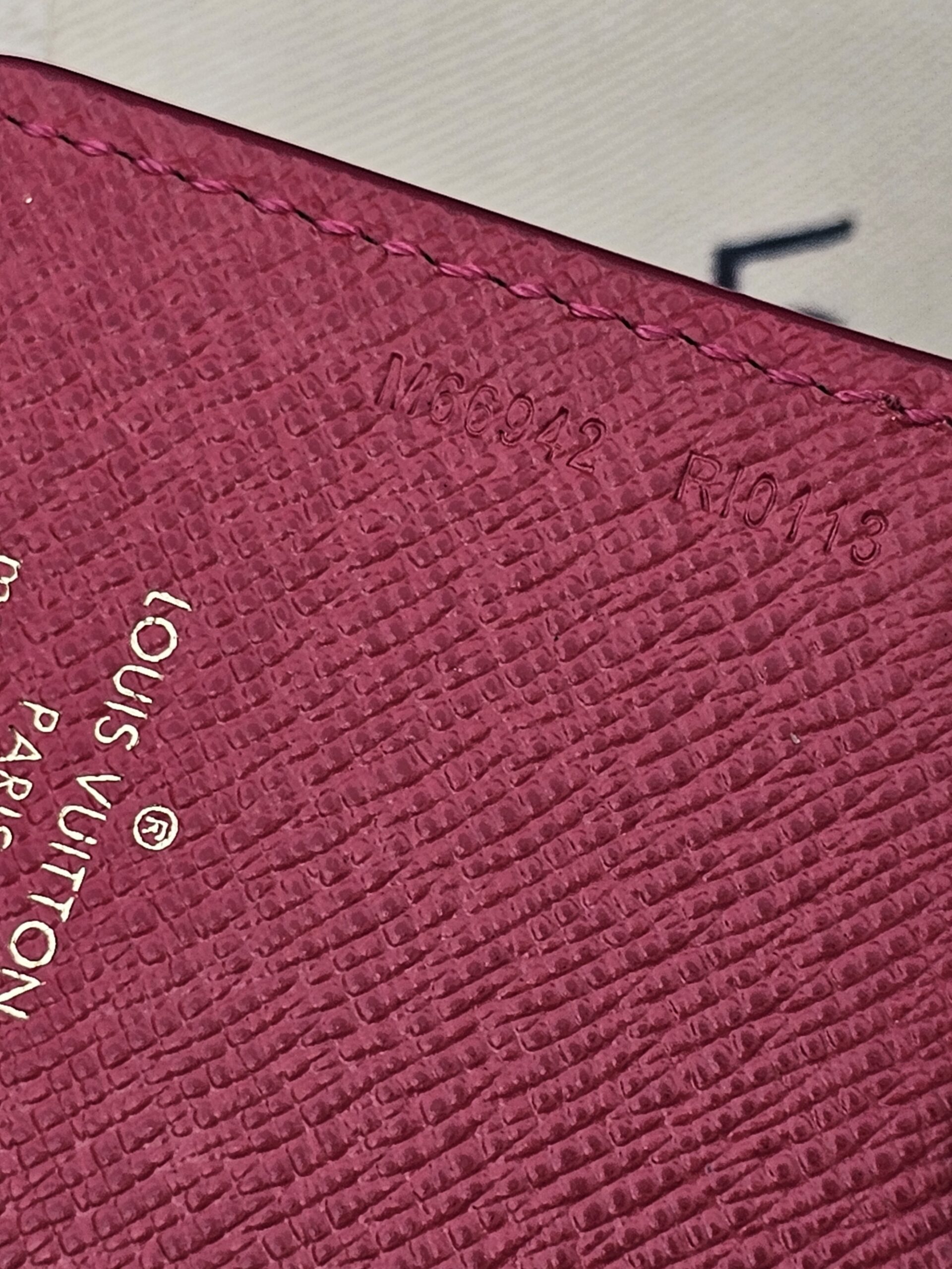 Close-up of the pink leather and Louis Vuitton Paris stamp on the Illustre Carousel charm