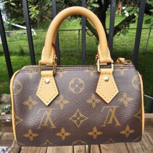 Angled front view of the Louis Vuitton Nano Speedy Bandouliere showing the crisp Monogram print across the body