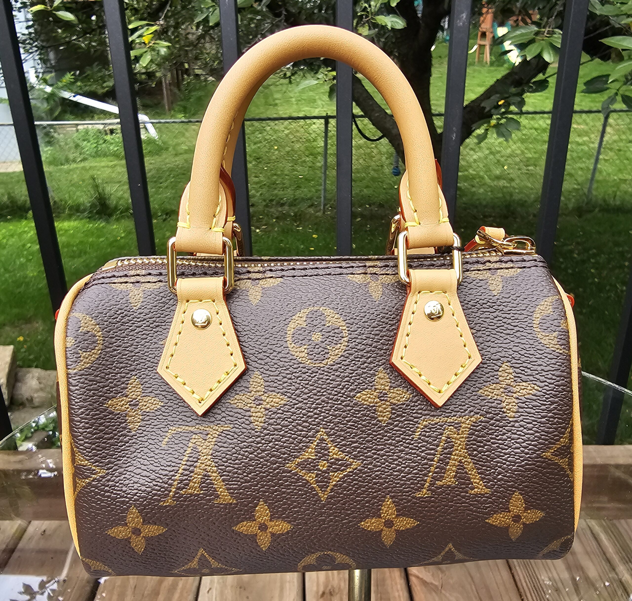 Angled front view of the Louis Vuitton Nano Speedy Bandouliere showing the crisp Monogram print across the body