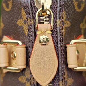 Top of the Louis Vuitton Nano Speedy Bandouliere with the gold-tone zip closed and both leather pulls together