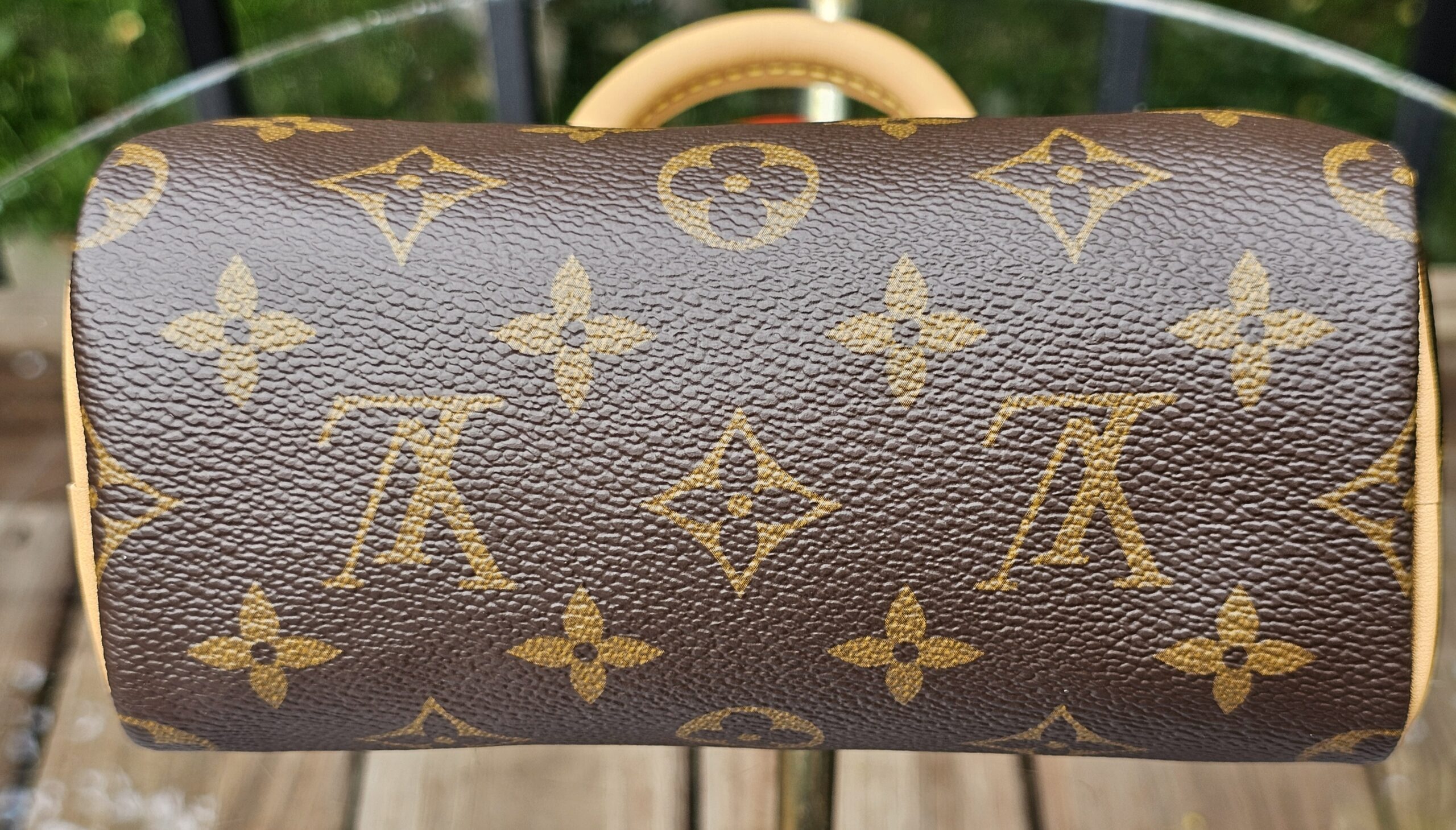 Rounded end panel of the Louis Vuitton Nano Speedy Bandouliere showing the Monogram canvas pattern
