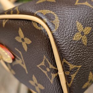 Close-up of a corner of the Louis Vuitton Nano Speedy Bandouliere showing the condition of the vachetta piping