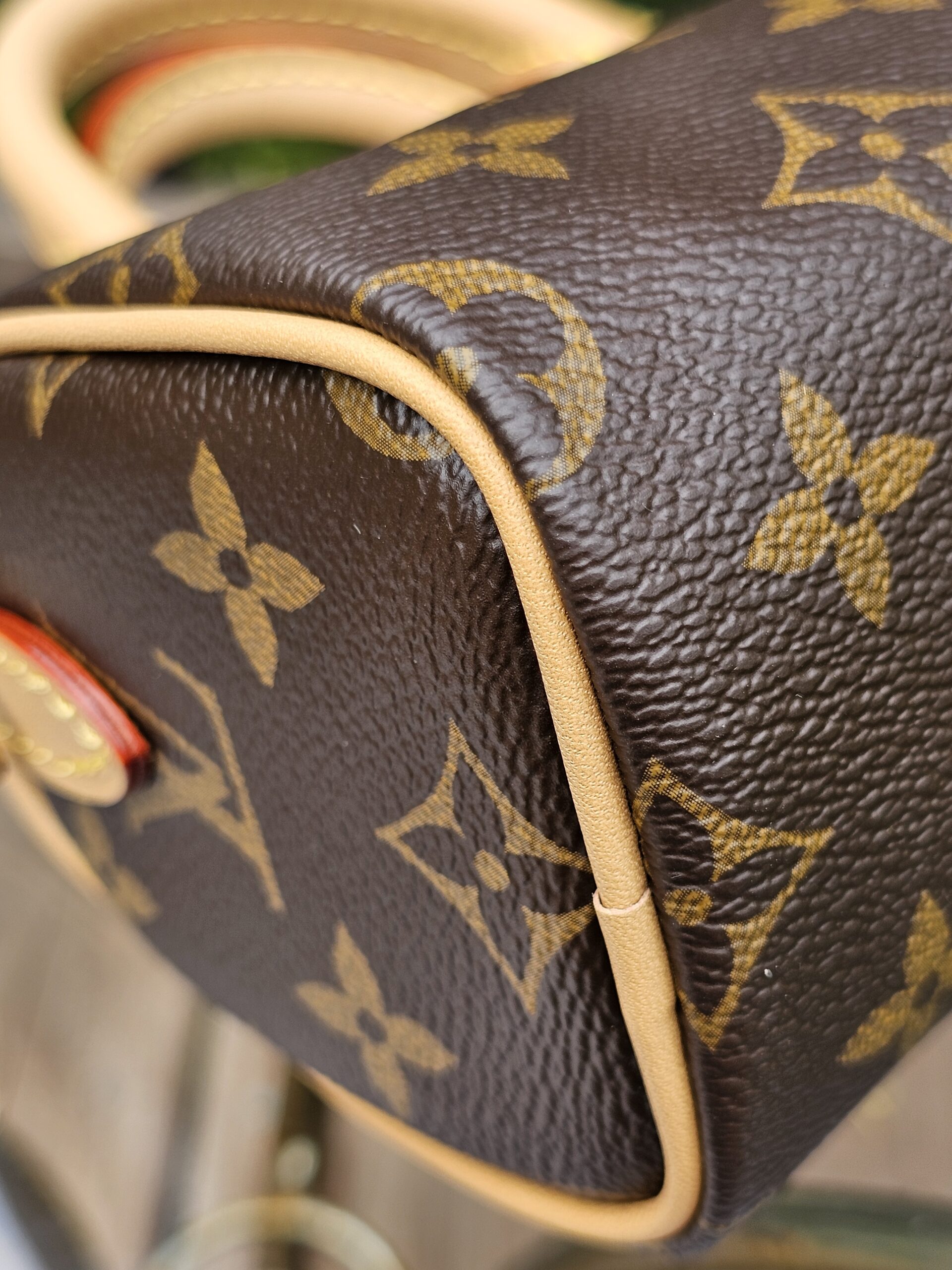 Close-up of a corner of the Louis Vuitton Nano Speedy Bandouliere showing the condition of the vachetta piping