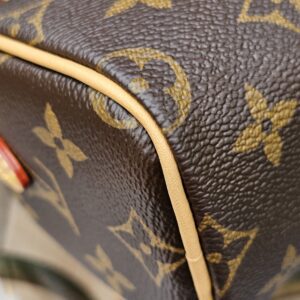 Vachetta piping along the edge of the Louis Vuitton Nano Speedy Bandouliere shown for condition