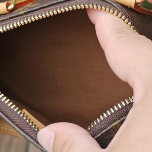 Interior of the Louis Vuitton Nano Speedy Bandouliere showing the clean brown textile lining through the open zip