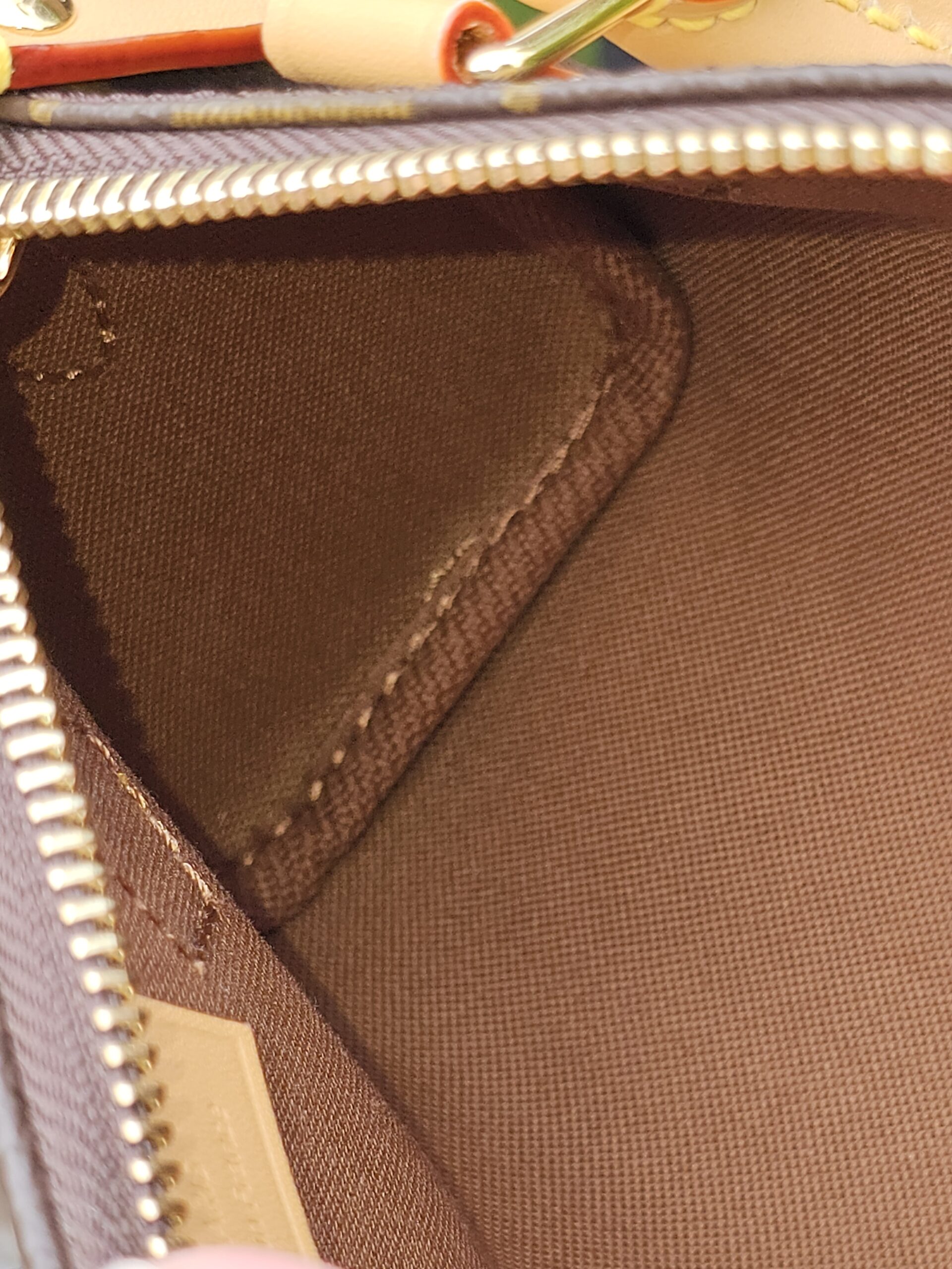 Brown textile lining and interior seams of the Louis Vuitton Nano Speedy Bandouliere