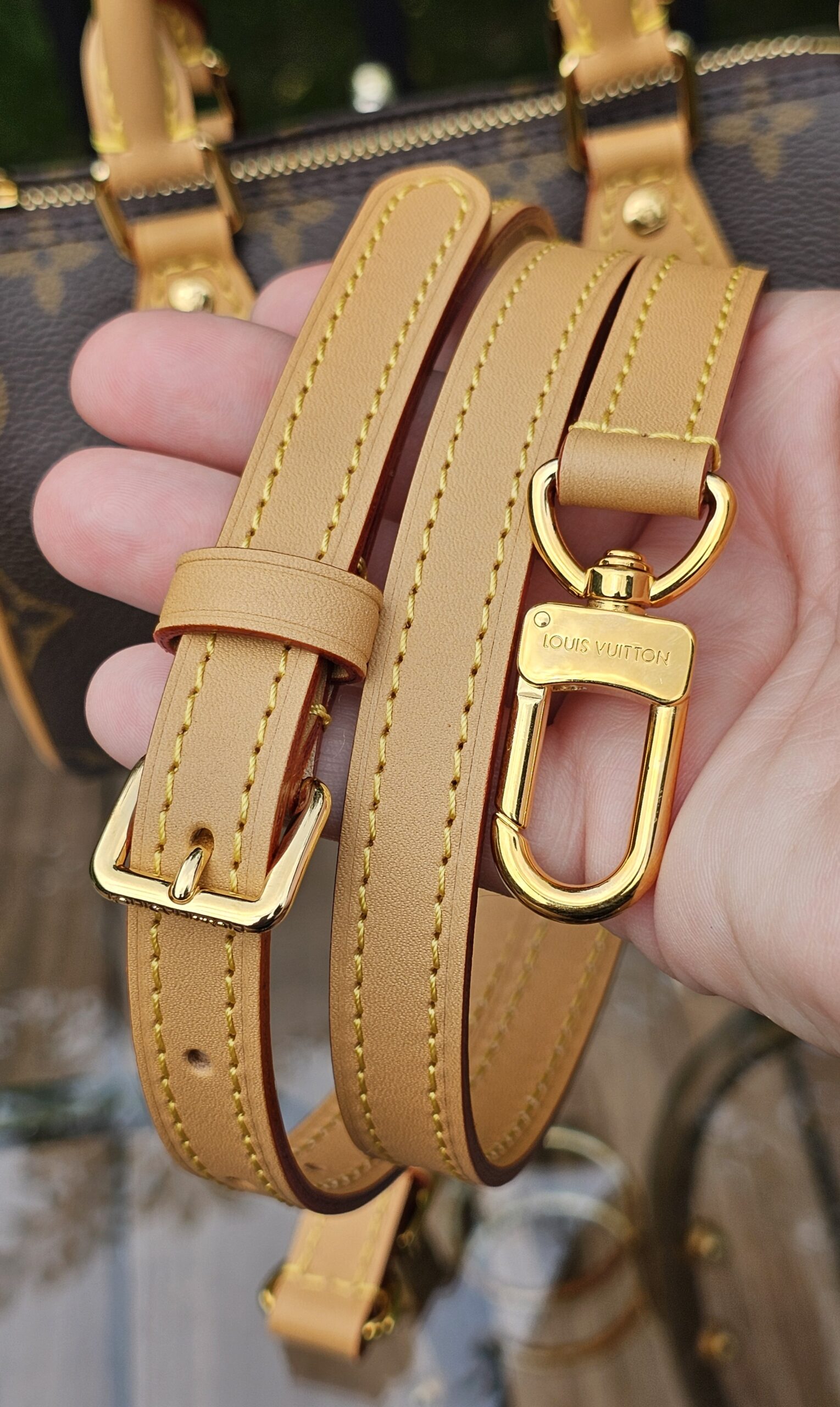 Removable adjustable vachetta leather crossbody strap for the Louis Vuitton Nano Speedy Bandouliere held in hand