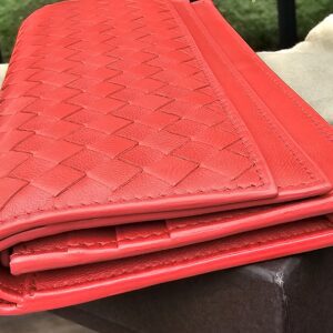 Side profile of the Bottega Veneta Intrecciato continental wallet showing its depth