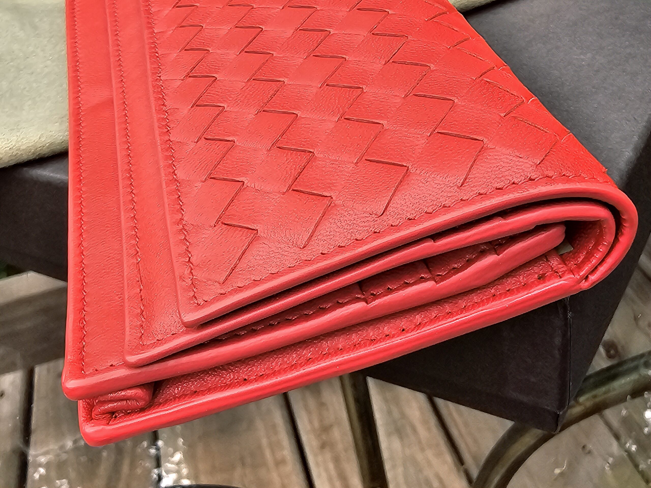Close-up of the Intrecciato weave on the Cassis Nappa leather of the Bottega Veneta wallet
