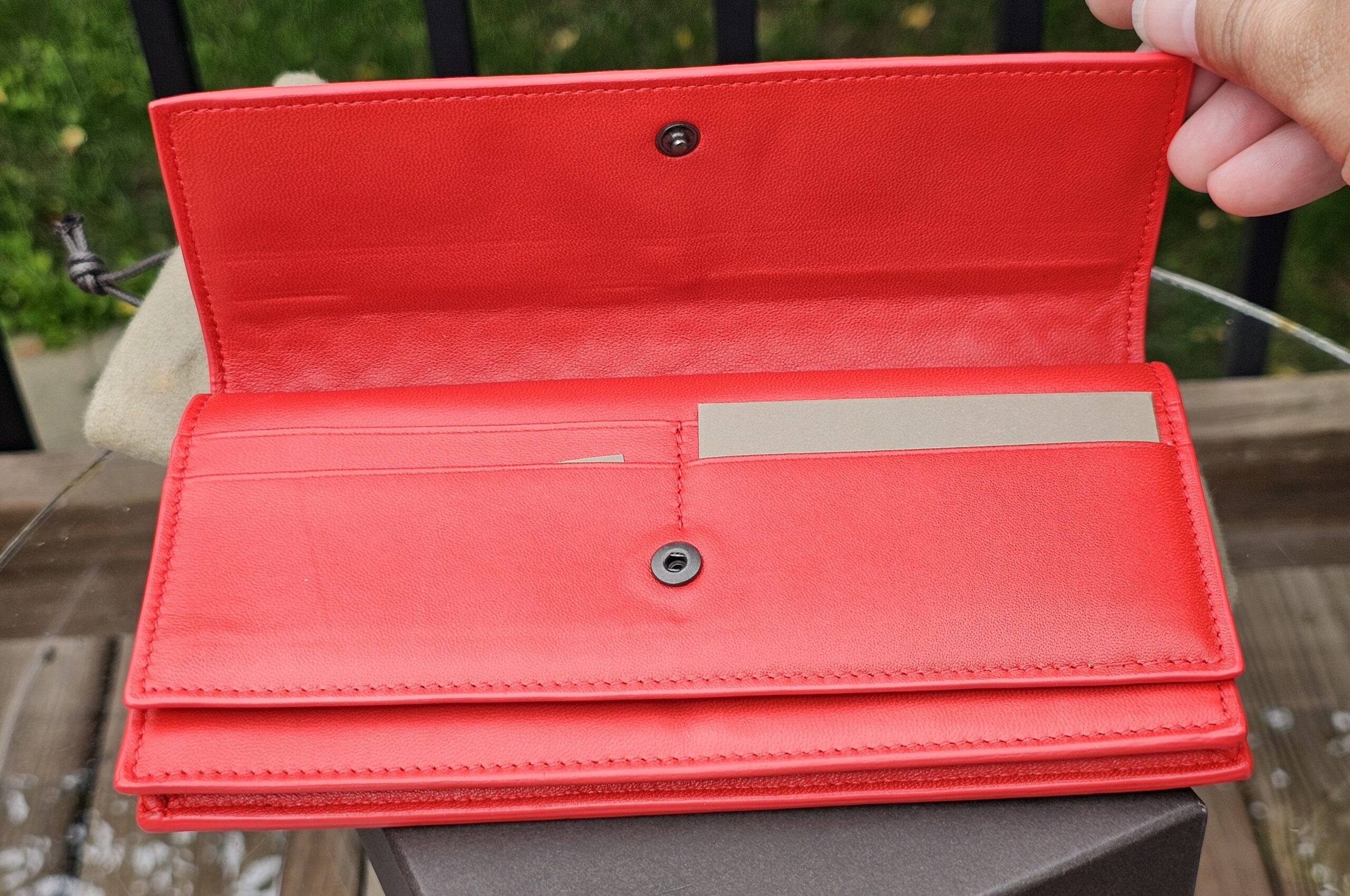 Interior of the Bottega Veneta continental wallet with card slots and bill compartments in Cassis leather