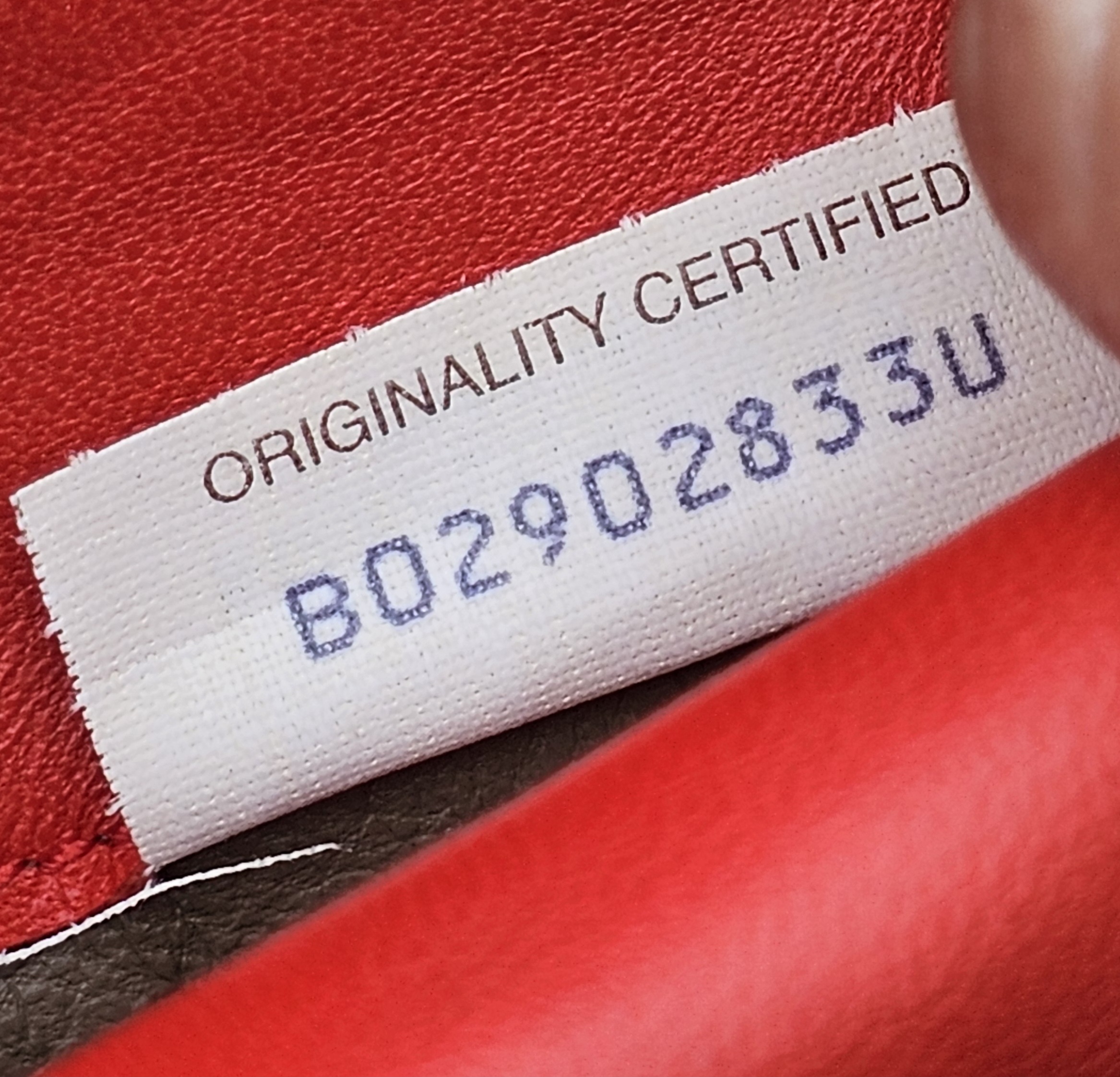 Originality Certified tag reading B02902833U inside the Bottega Veneta Intrecciato wallet
