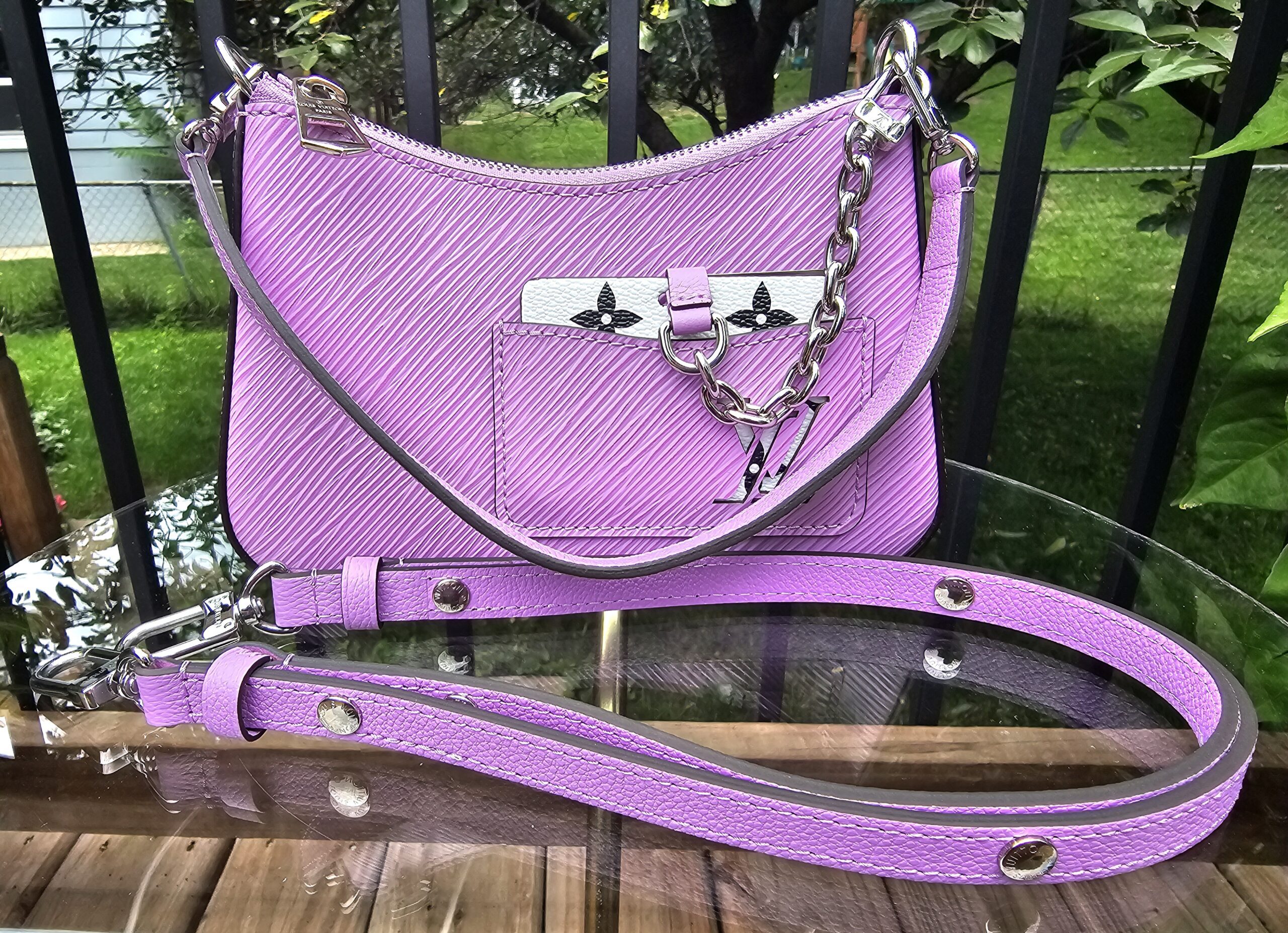 Louis Vuitton Epi Marellini in purple with both detachable straps and matching coin pouch laid out