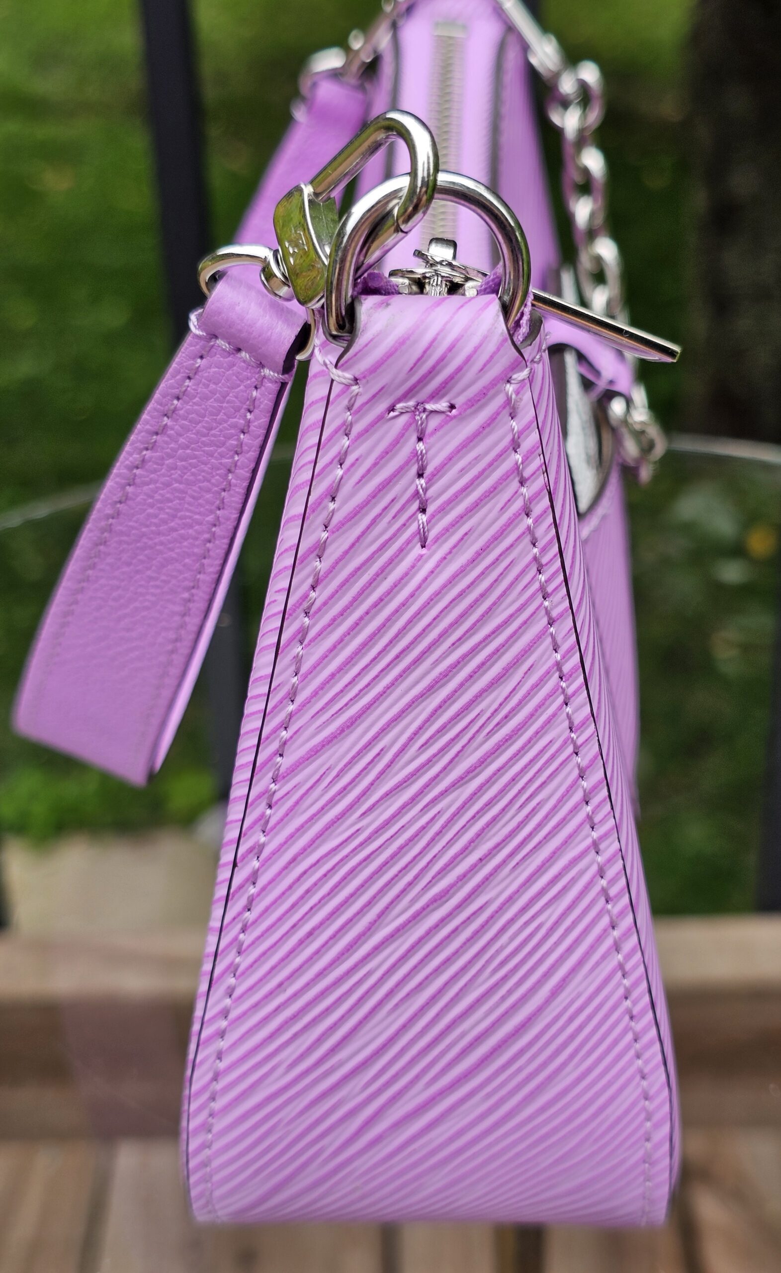 Silver-tone hardware attaching the strap to the Louis Vuitton Epi Marellini