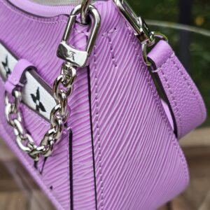 Monogram charm and silver-tone chain on the front of the Louis Vuitton Epi Marellini