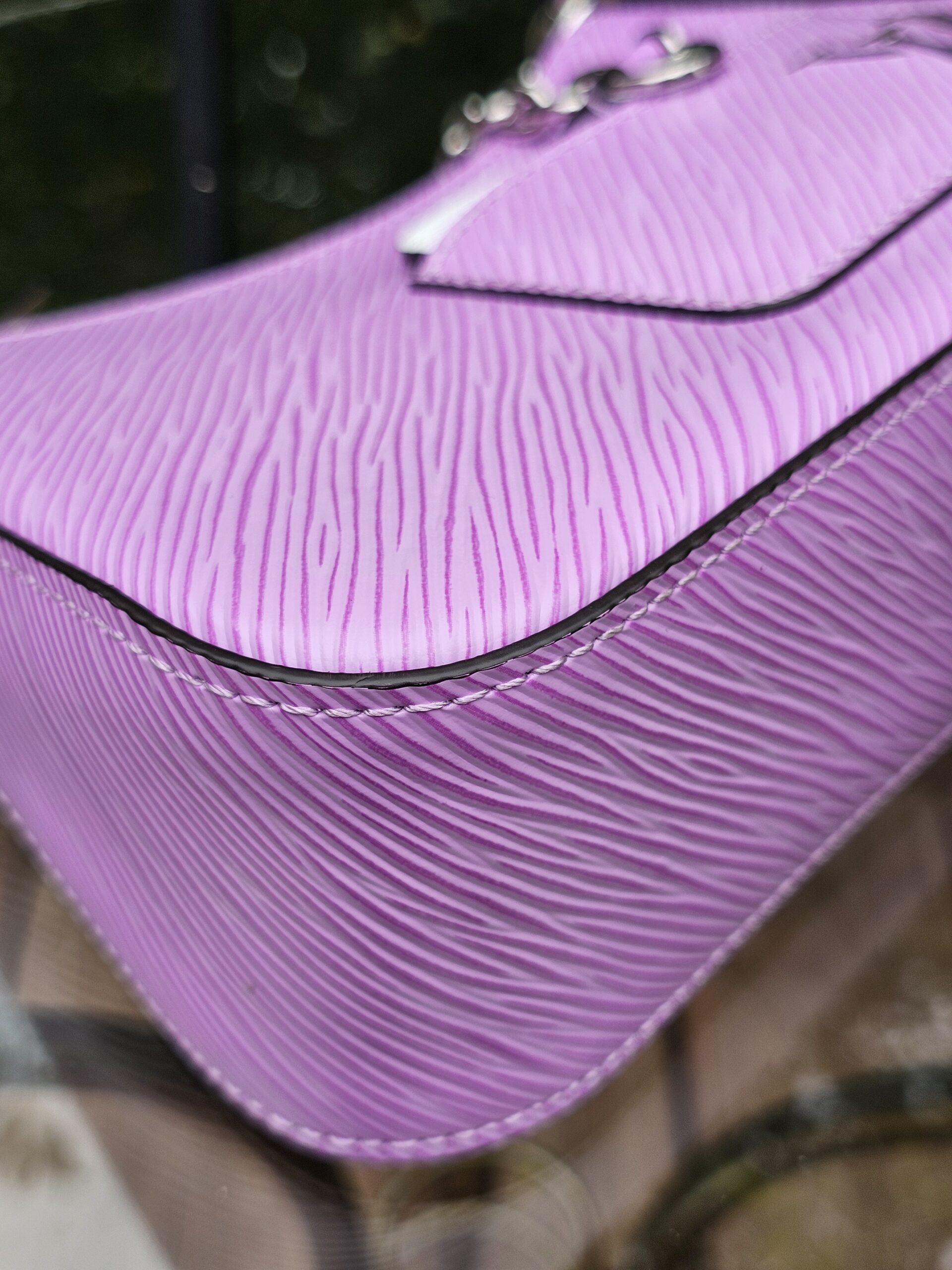 Close-up of the crisp purple Epi leather grain on the Louis Vuitton Marellini