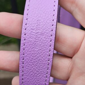 Purple Epi leather shoulder strap for the Louis Vuitton Marellini held in hand