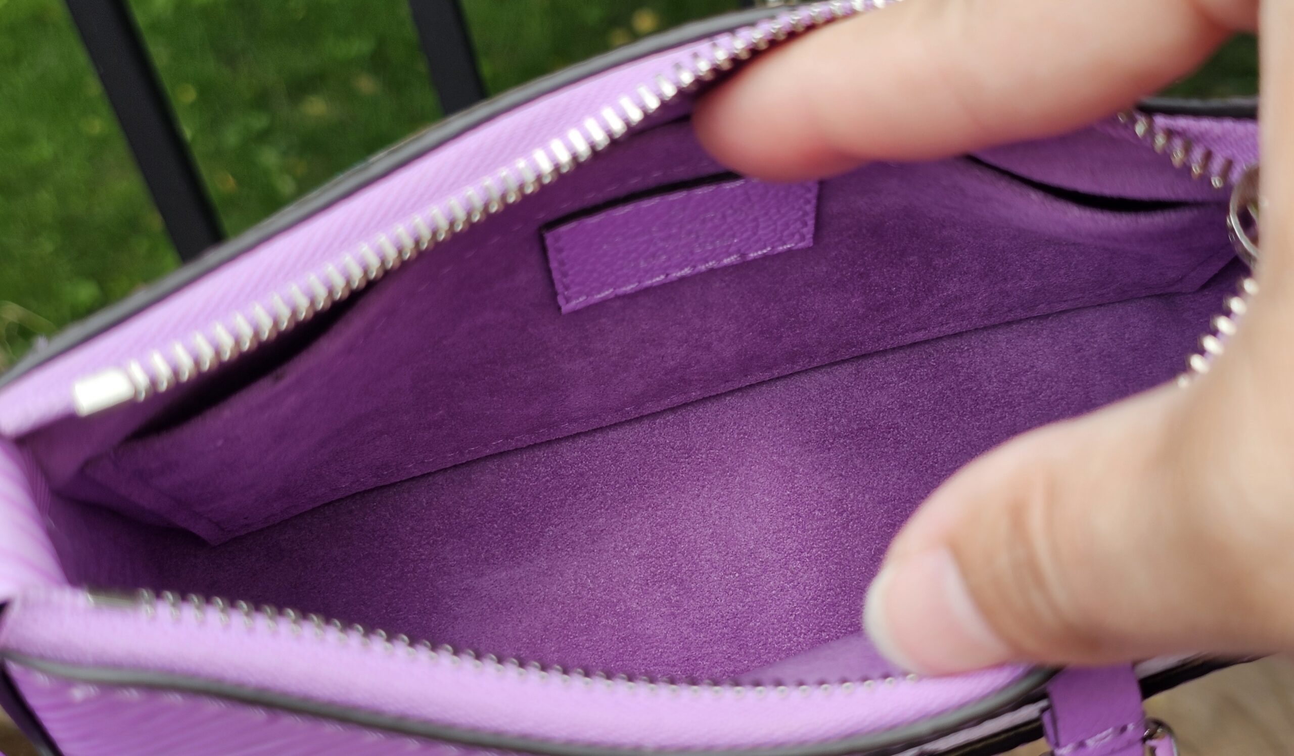 Interior of the Louis Vuitton Epi Marellini lined in purple microfiber