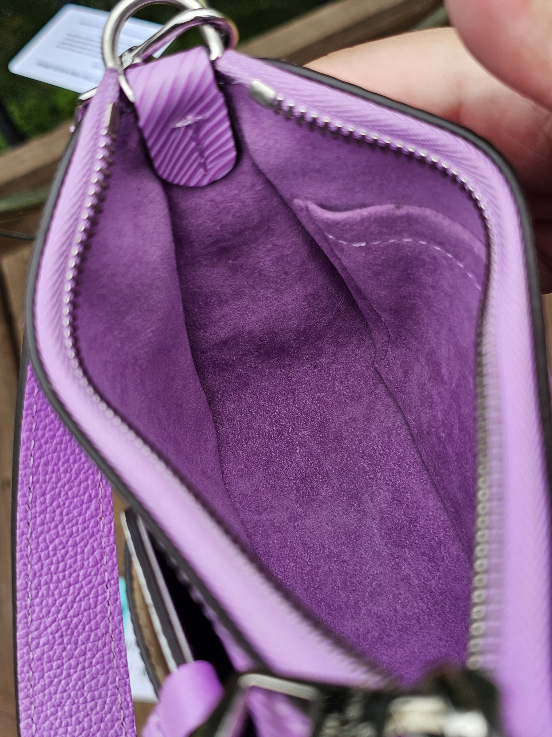 Louis Vuitton Epi Marellini held open showing the clean purple interior