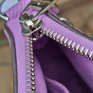 Silver-tone zip and purple lining inside the Louis Vuitton Epi Marellini