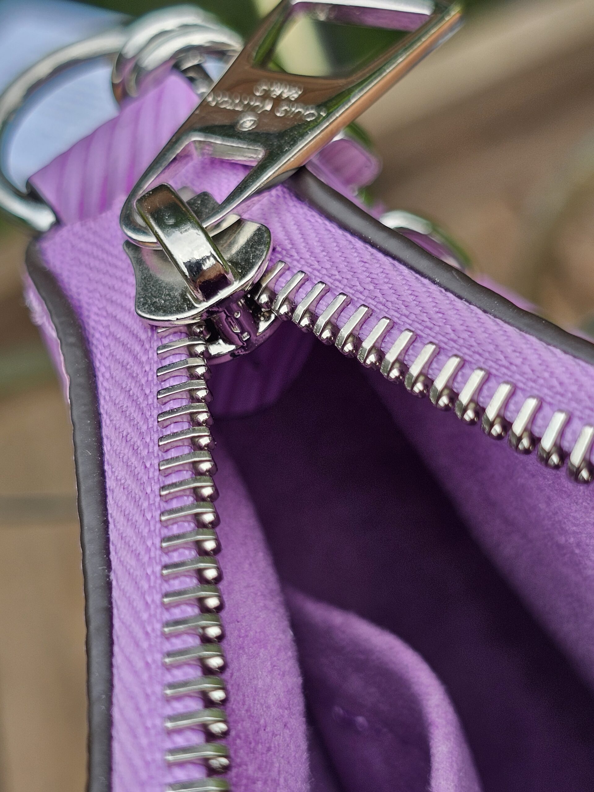 Silver-tone zip and purple lining inside the Louis Vuitton Epi Marellini