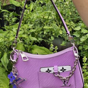 Louis Vuitton Epi Marellini in purple hanging by its chain strap outdoors